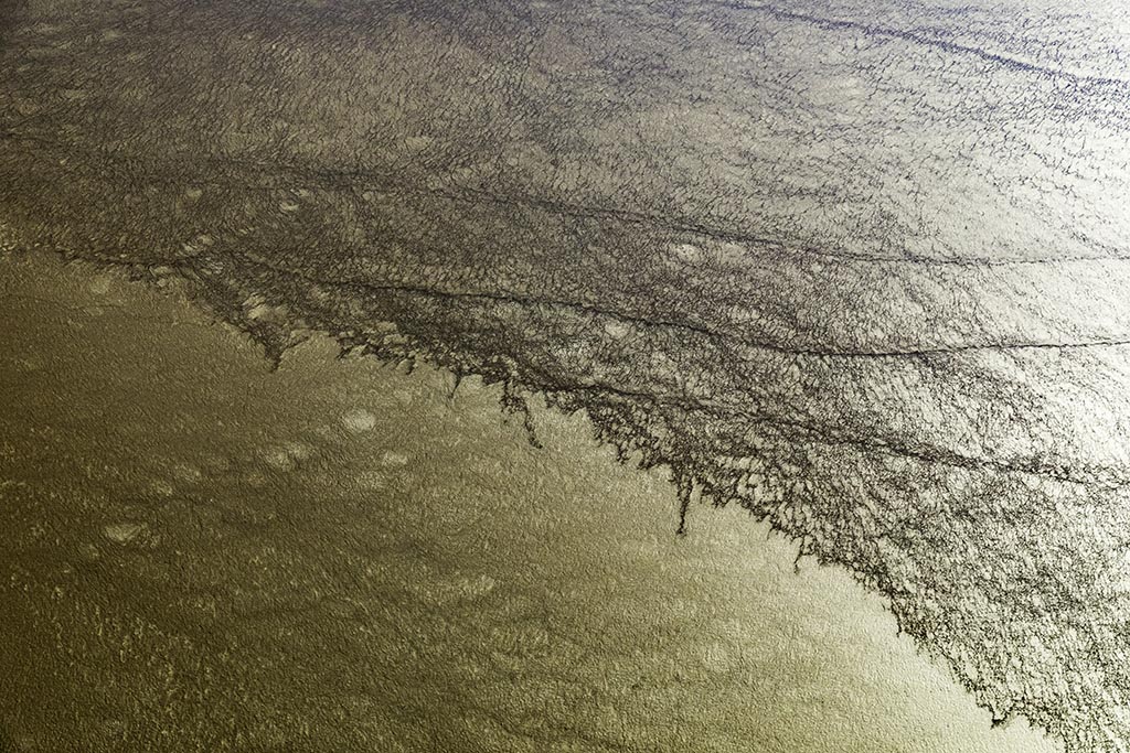 Golden afternoon light highlights the patterns in the surface of Lake Eyre