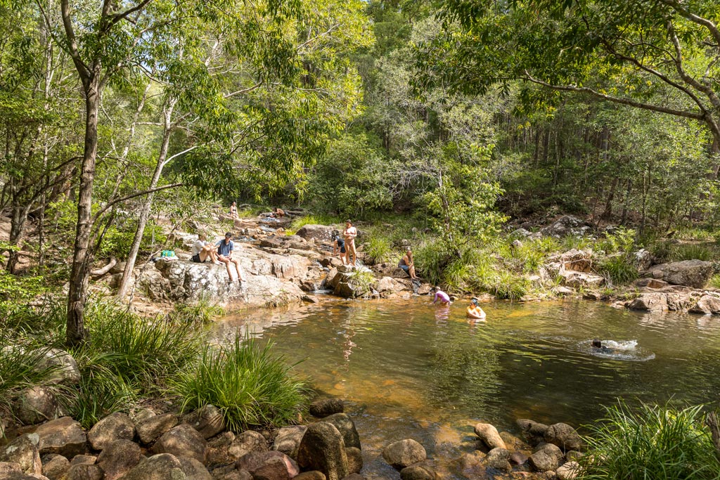 People swimming and sun baking at Mothar Mountain Rock Pools
