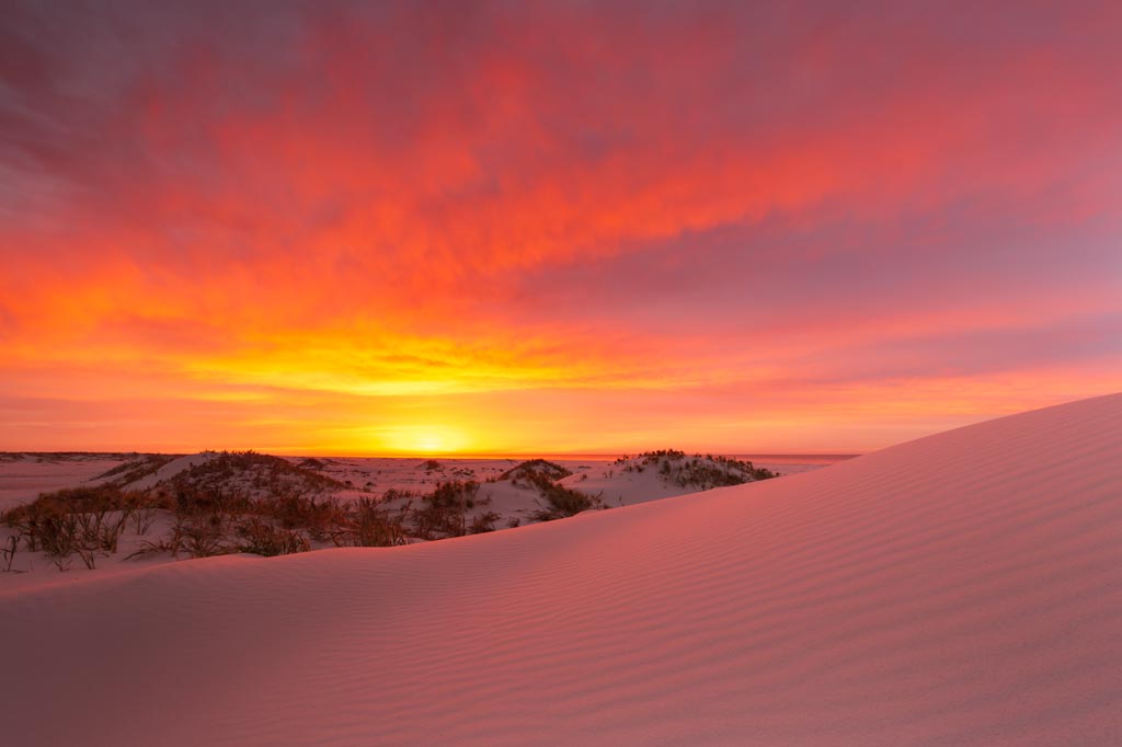 Spectacular sunrise with sand dunes in the foreground - 6 tips to improve your landscape photography
