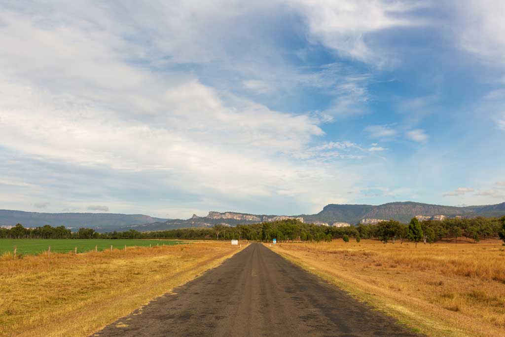 sealed road with Carnarvon Gorge in the background