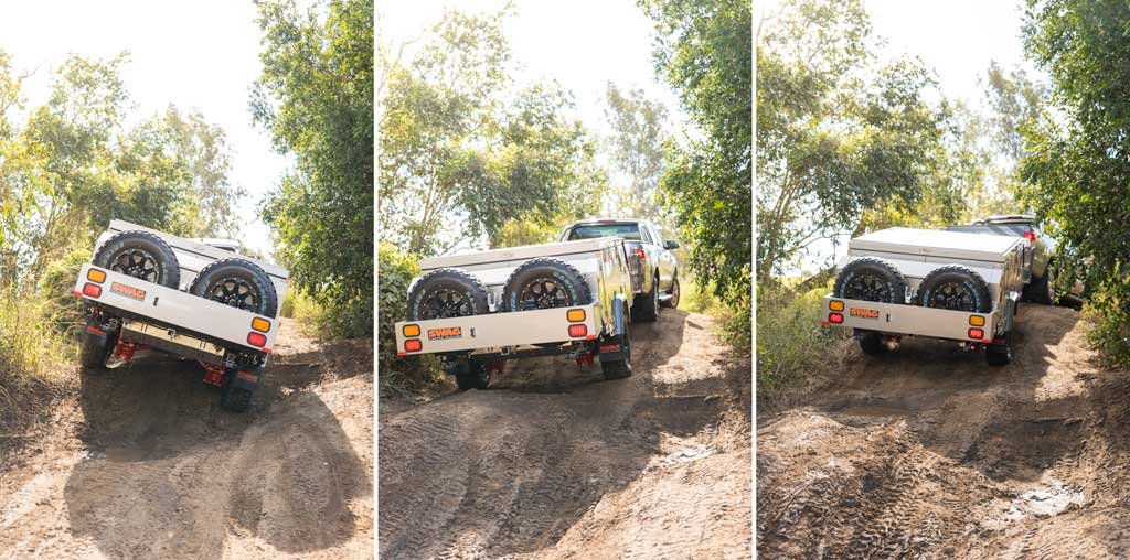 forward fold camper trailer being towed up a 4wd track